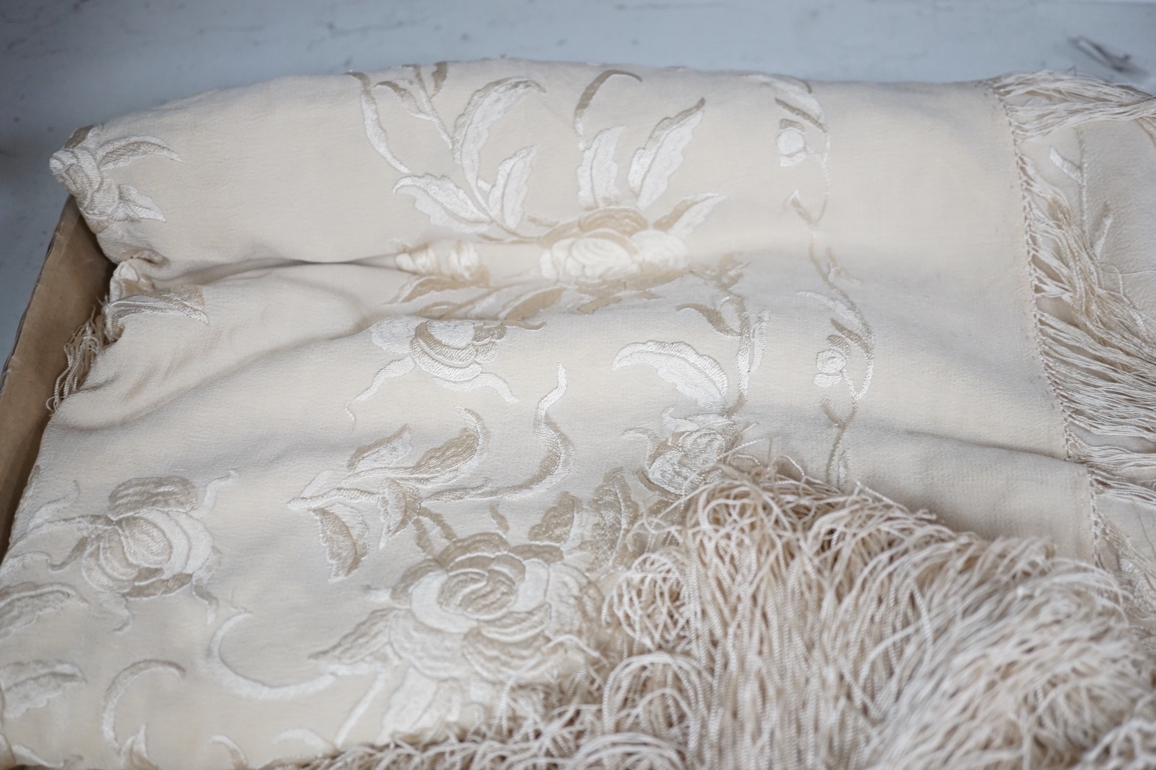 A 19th century cream embroidery on cream silk shawl together with a smaller later shawl